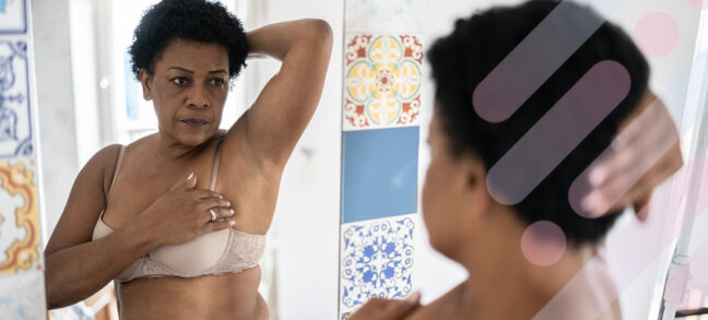 Woman placing her hand on her breast to demonstrate a breast self-exam