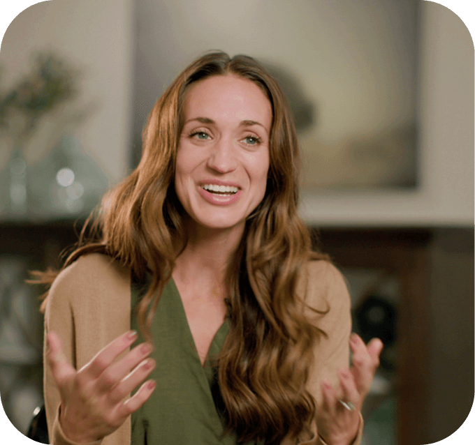 Leanna gestures at the camera while telling her story